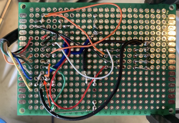 The joystick PCB, with a red arrow pointing to the inadvertent solder bridge between pins 5 and 8. Please don't look too closely at any of the rest of this, I am ashamed of my bodge-wire work.