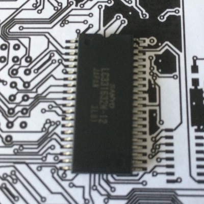 A paper RAM footprint, with a RAM chip sitting on top of it. All the legs are happily within the solder pads.