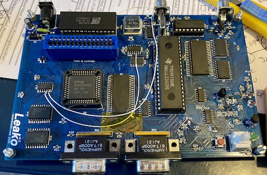 Bodge wires, affixed to the board with Kapton tape, are now running on both sides of the board. Two traces near U20 are obliterated.