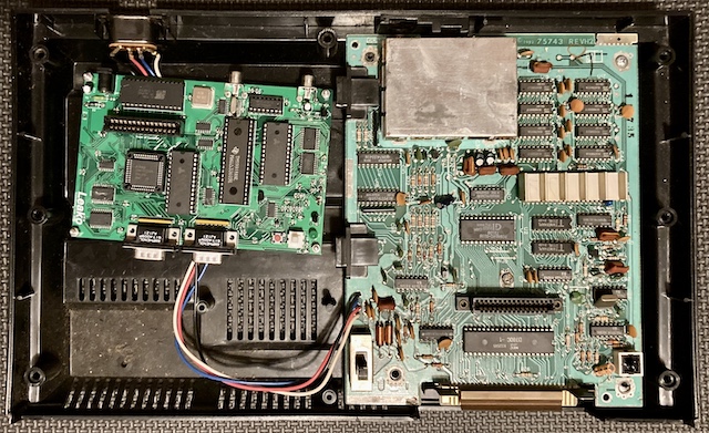 The Leako motherboard (left, small) mounted next to the ColecoVision motherboard (right, larger)