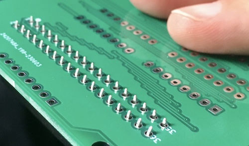 After butchering the pins of the connector, it now fits through the holes and can be soldered to the board.