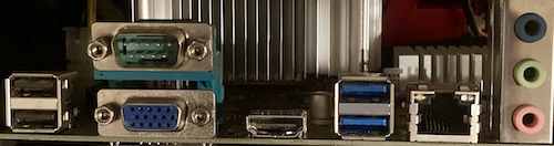 The ports on the back of the motherboard. Two black USB ports are stacked on top of each other, then a 9-pin male DE9, a female 15-pin VGA, an HDMI connector, two blue USB ports, an RJ45 ethernet jack, and three audio jacks: blue, green, and red.