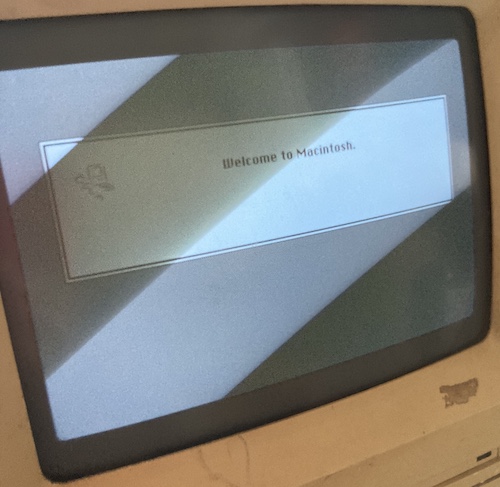 The Macintosh is booted to the "Welcome to Macintosh" screen.