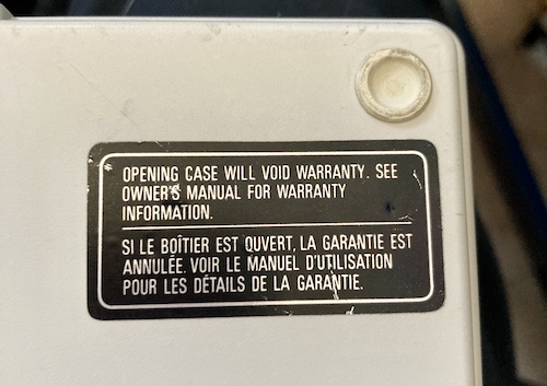 The "warranty void if removed" sticker, covering a screw hole.
