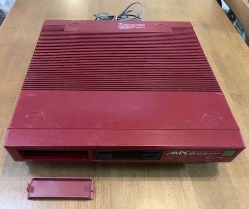 The Mr.PC as shown at auction. It's red, with some scratches, and the dummy cover for the 'missing' floppy drive has a broken tab.
