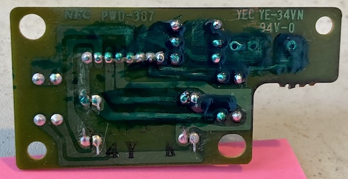 The exposed traces are now sealed up with some new green solder mask paint. The colour doesn't match and it's obvious there are some very deep globs. Some of the solder joints are even covered in it.