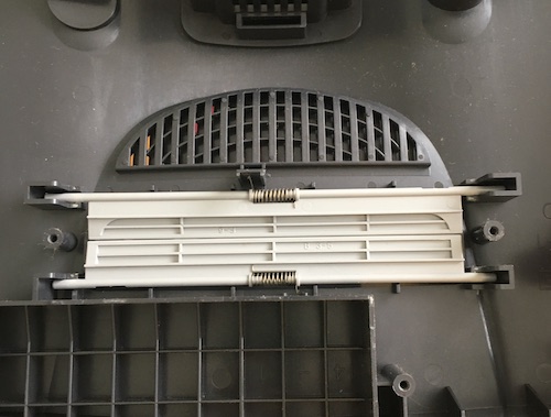 The cartridge tray has been removed, showing that the grey dust flaps of the top of the case are not held in by anything else.