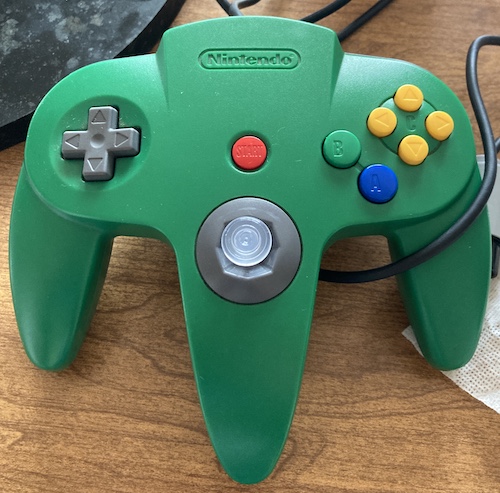 The green controller is reassembled, with a nice clear thumbstick sticking out of it.