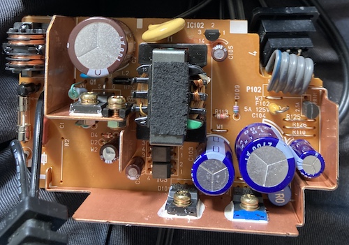 The N64 power supply has finally been opened. You can see a scrap of leftover tape on the top of the main transformer.