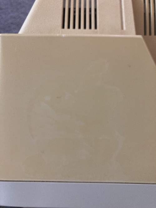 There is a faint outline of an Apple logo sticker on the top of the case.