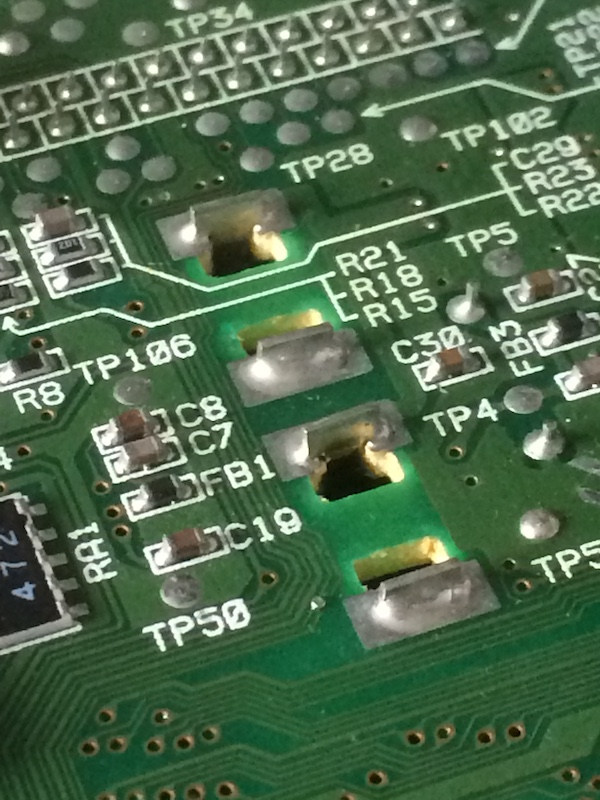 The solder joints holding the Nomad power prongs to the mainboard, from the inside