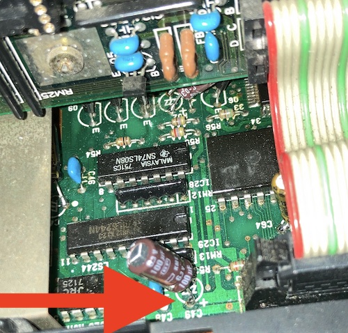 Someone has tried to replace the electrolytic capacitor at C49, and ended up just soldering it to the existing capacitor legs. 