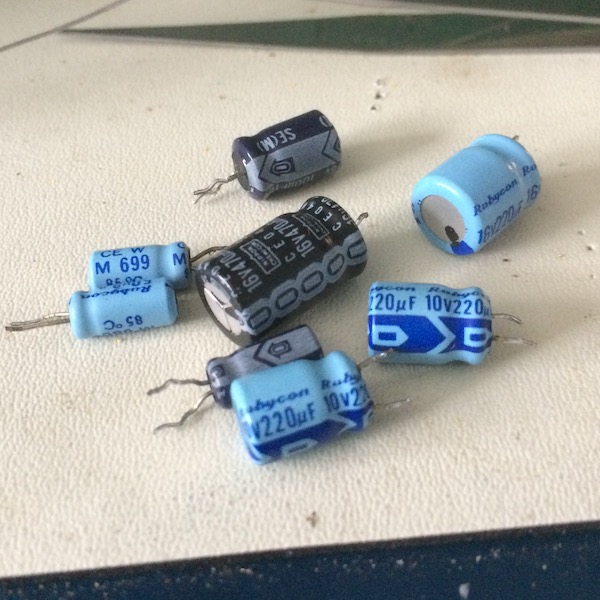 All eight electrolytics removed, sitting on the ESD mat and contemplating their failure