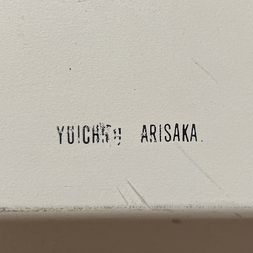 A stamp on the top of the case reads "YUICH... ARISAKA" but the last letters of the first name are damaged and unreadable.