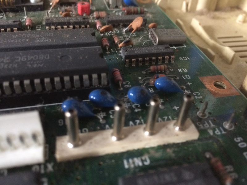 The blue through-hole tantalum capacitors on the power rail. There are four of them - GND, +5V, -12V and 12V