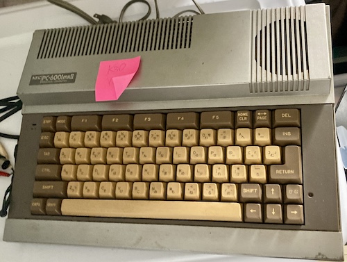 The PC-6001mkII has been removed from storage. It has scratched silver paint and a very yellow-browny keyboard.