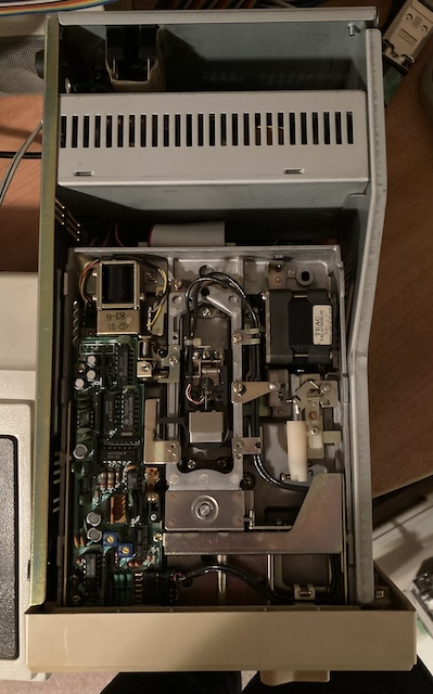 The outer case of the PC-80s31 is removed, showing the drive inside.