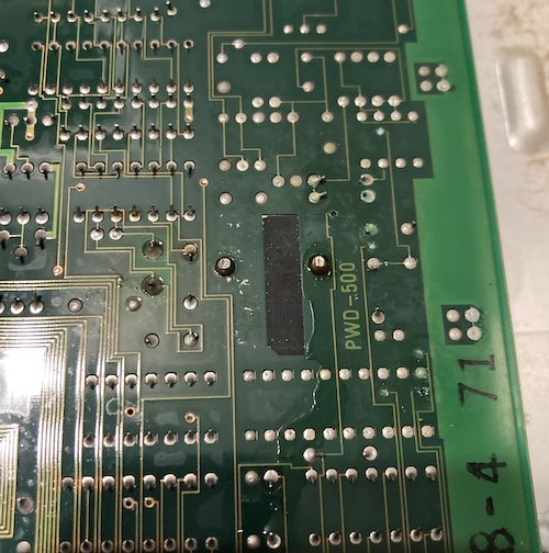 The underside of the battery area; the solder joint on the right is the battery's negative terminal.