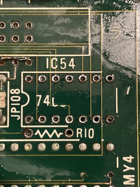 IC54 (the 7406) is now completely removed. You can see "74" and then part of a "06" left behind on the silkscreen, which is floating away.