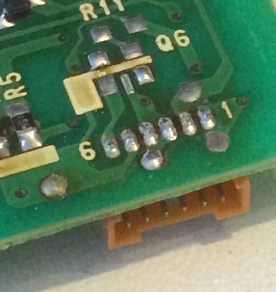 Corroded-looking 'cold' solder joints on the CN1 connector.