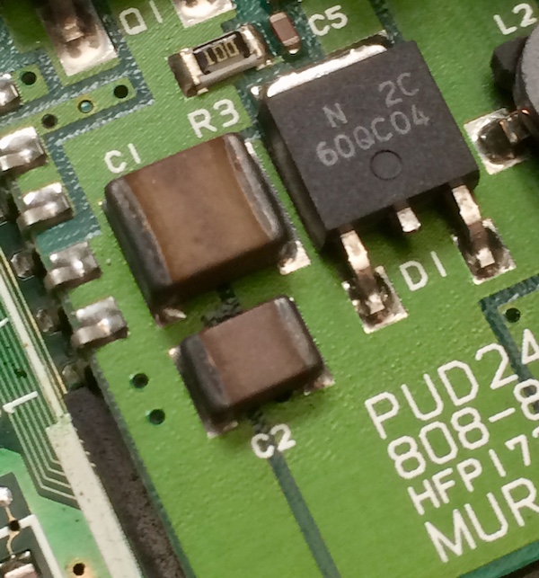 Burned-looking surface-mount bipolar ceramic capacitors on the Murata LCD control board.