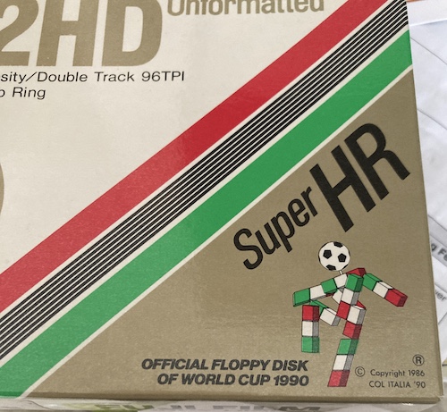 A box of FujiFilm "Super HR" floppies, advertising the 1990 World Cup. An ominous arrangement of Italian-coloured Legos, with a soccer ball for a head, menaces the unseen audience.