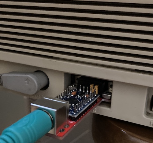 The mouse adapter plugged into the PC-98's front panel.