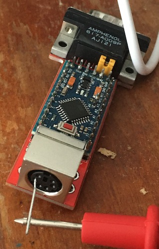 Using a bent staple to probe the power pin on the adapter's board.