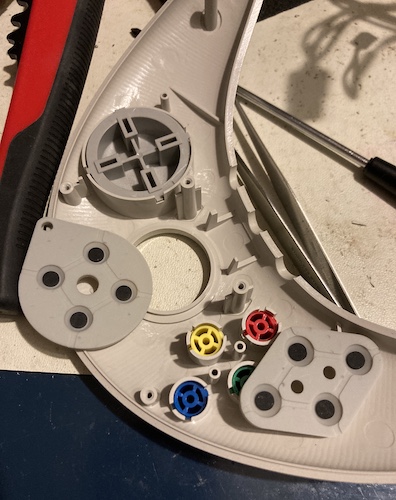 The controller membranes for the d-pad and the action buttons are exposed.