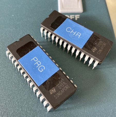 The two 27c512 EPROMs being used for the project. One says "PRG" and one says "CHR."