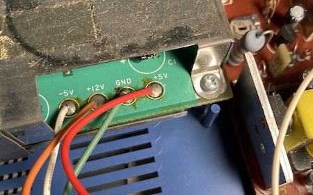 The colours and label of the power supply rails on the Pyuuta. White is -5VDC, orange is +12VDC, green is ground, and red is +5VDC. Hope you're not colourblind.