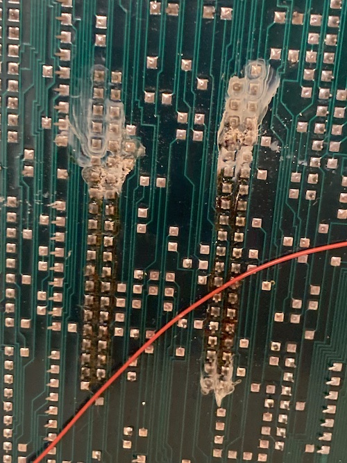Ugly white residue and dirty old flux washing off the pins of two card connectors after a quick visit to the sink.