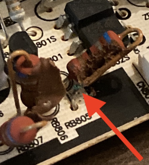 Some sort of blue-green copper oxide is revealed at the base of one of the resistors.
