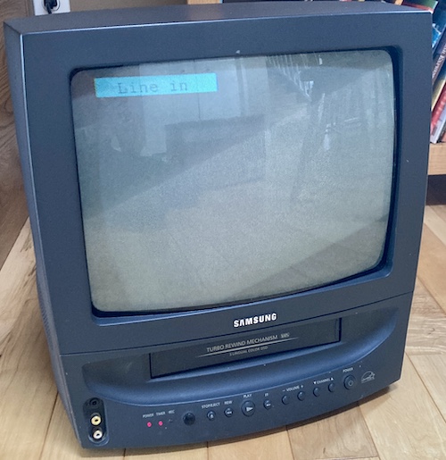 The television set is running, and shows an OSD message reading "Line in."