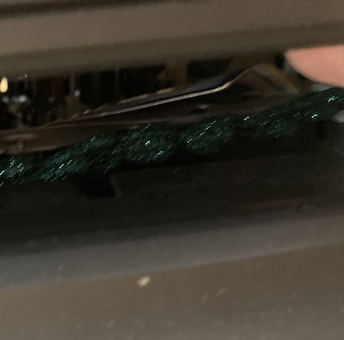 The VCR slot has some green sparkly thing stuck inside it.