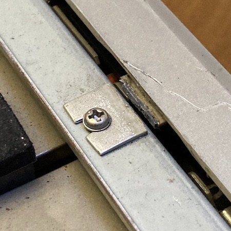 A broken plastic fascia clip on the top of the case. It looks like it was glued together at one point but has just failed again. Luckily, the clip was screwed in tightly, so it hasn't gone missing.