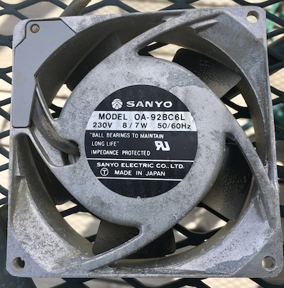 The cooling fan's label. It says SANYO MODEL OA-92BC6L; 230V, 8/7W, 50/60Hz, "BALL BEARINGS TO MAINTAIN LONG LIFE" IMPEDANCE PROTECTED SANYO ELECTRIC CO, LTD. MADE IN JAPAN