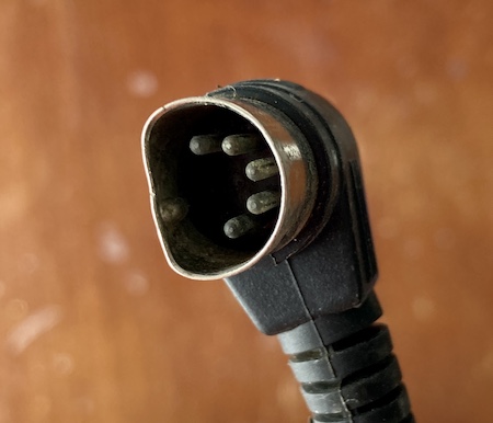 The 5-pin DIN connector has had its circular shield squashed until it more closely resembles a D-sub connector.