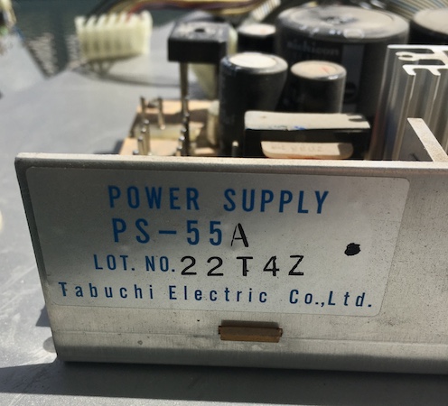 The label on the side of the power supply. It says POWER SUPPLY PS-55A Tabuchi Electric Co., Ltd