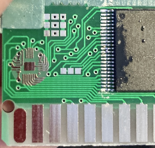 An unpopulated high-density chip pad in the corner, and some spots for adding resistors or possibly jumpers are exposed.