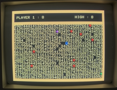 Numbertron running on my CRT. A smiley face sits in a field of numbers, questing for treasure.