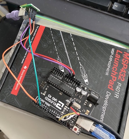 The prototype wiring for the keyboard adapter. A small PS/2 port is wired into the Arduino clone with a bunch of precariously tensed male-to-female jumper wires.