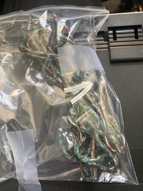 The cracked and stringy keyboard cable in a Ziploc bag.