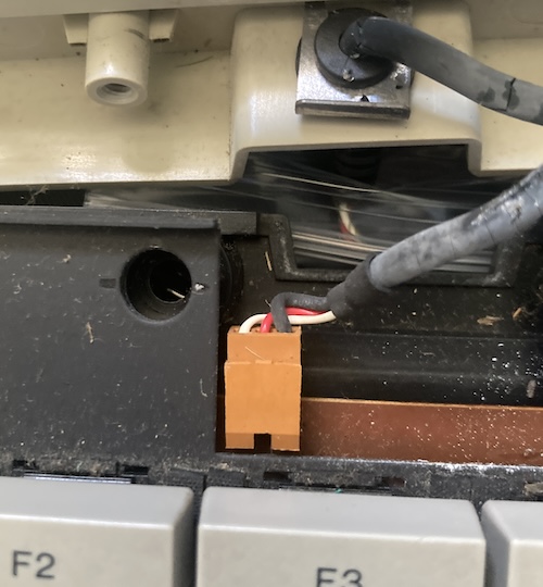 The internal connector, connected to the board. The pinout from left to right is white, red, black