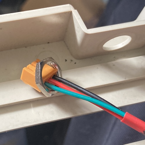 The nut can't come off the connector, which makes it impossible to put on the other side in order to fasten the connector to the plastic.