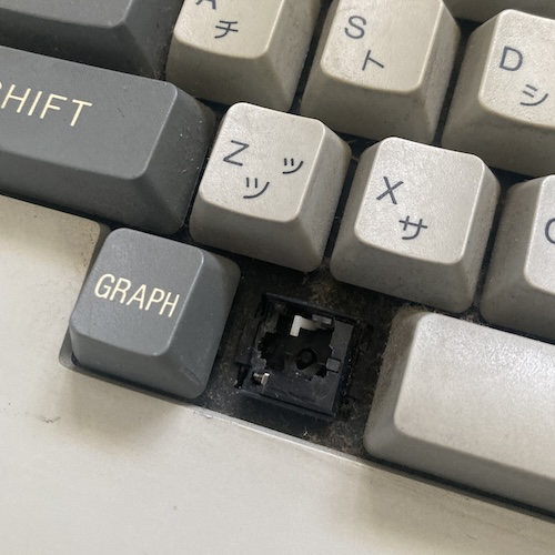 A jagged hole remains where a Caps Lock key once was.