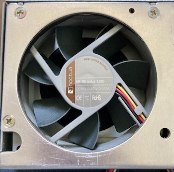 The fan is poking out of the hole in the side of the power supply.