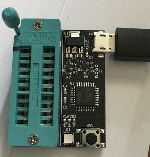 Simon Raybould's 4-bit RAM tester, sitting on some papers. Notice that there is a Sharpie mark indicating "pin 1." The microcontroller running this is an STM32G of some sort.