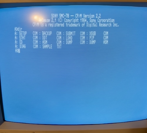 The sign-on banner for Sony SMC-70 CP/M version 2.2, containing the files SETUP.COM, STAT.COM, ED.COM, DIAG.COM, BACKUP.COM, DDT.COM, ASM.COM, SAMPLE.TXT, SUBMIT.COM, LOAD.COM, DUMP.COM, XSUB.COM, PIP.COM, and DUMP.ASM