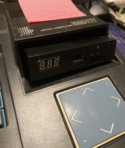 The Gotek is dangling loosely out the front of the SMC-777's case.